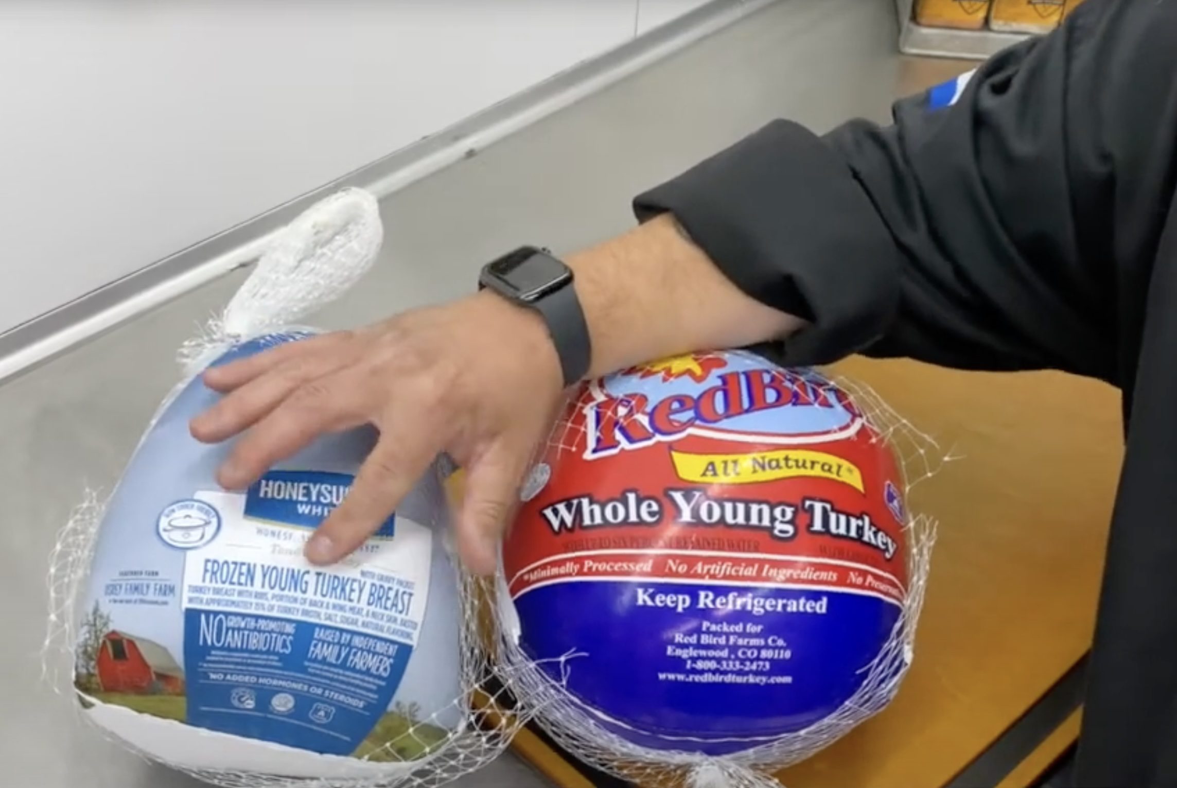 Man pointing to turkey packaging.