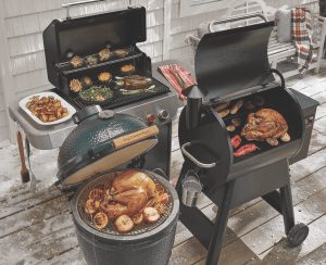 Turkey cooking on a grill outside.